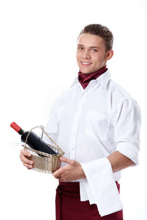 The young waiter with a bottle of wine on a white backgroundの写真素材