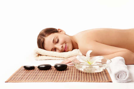 Young naked girl on spa treatments on a white backgroundの写真素材