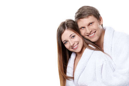 Young attractive couple in dressing gowns on white backgroundの写真素材