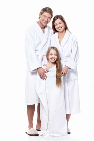 Young family in robes on a white backgroundの写真素材