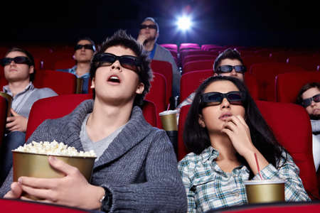 Surprised people in 3D glasses in cinemaの写真素材