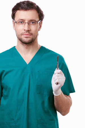 A young surgeon with a scalpel on a white backgroundの写真素材