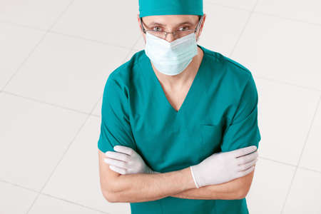 Surgeon in mask and gloves indoorsの写真素材