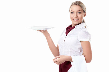 Attractive girl with an empty plate on a white backgroundの写真素材