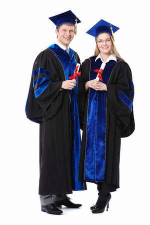 Two students with diplomas on a white backgroundの写真素材