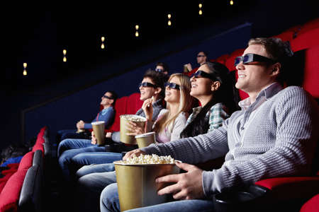 Young people watch movies in cinemaの写真素材