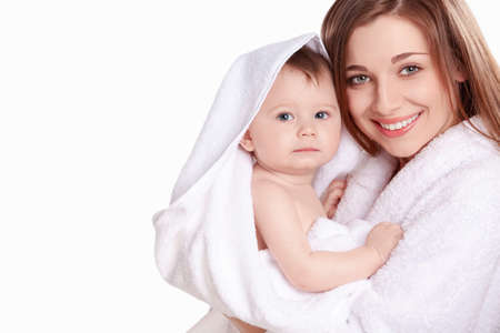 Young mother with her baby in a white towelの写真素材