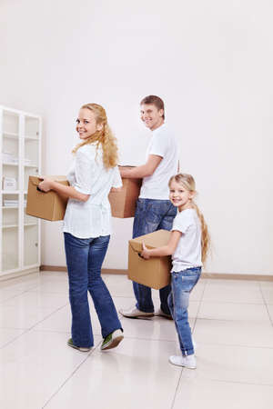 Parents with a child are cardboard boxes indoorsの写真素材