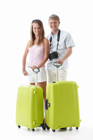 An attractive couple with suitcases on a white backgroundの写真素材