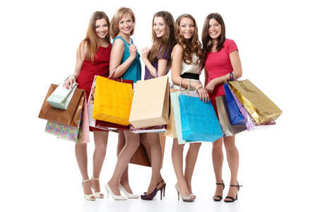 Five attractive young women with shopping on white backgroundの写真素材
