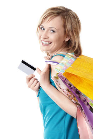 Young girl with bags and credit card on a white backgroundの写真素材