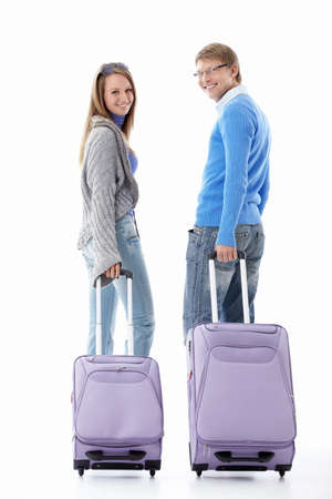 Attractive young couple with suitcases isolatedの写真素材