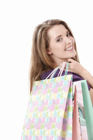 Young girl with shopping bags on white backgroundの写真素材