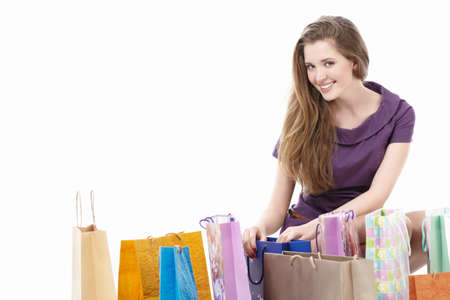 Attractive girl with shopping bags on white backgroundの写真素材
