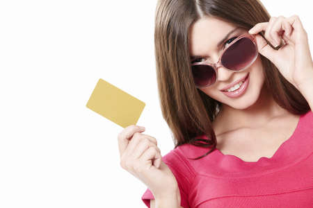 Attractive girl with a credit card on a white backgroundの写真素材
