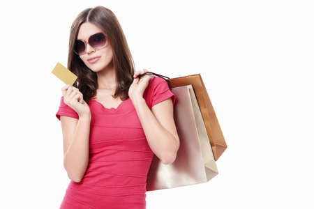 Attractive girl with shopping bags and credit card on a white backgroundの写真素材