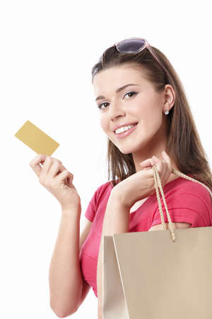 Young woman with shopping bags and credit card on a white backgroundの写真素材