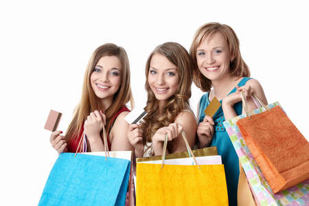 Beautiful girl with shopping bags and credit card on a white backgroundの写真素材