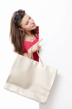 Attractive young girl with a bag, and billboardsの写真素材