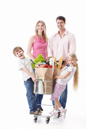A happy family with a cart with food on a white backgroundの写真素材