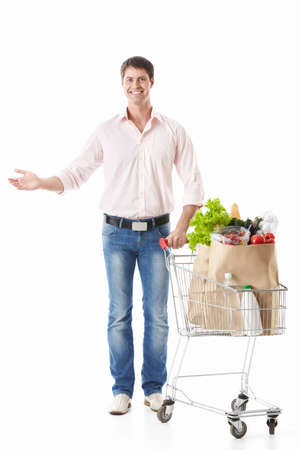 A happy man with a cart with food on a white backgroundの写真素材