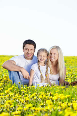 Young family with a child in fieldの写真素材