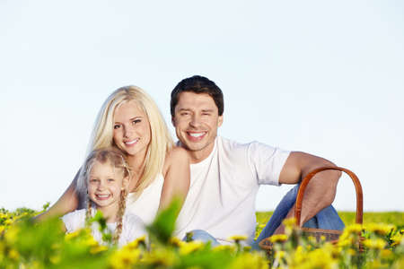 Young family with a child in fieldの写真素材