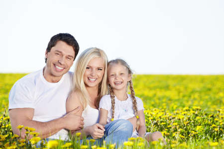 Happy young family in the fieldの写真素材