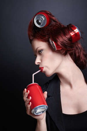 An attractive young woman drinkingの写真素材