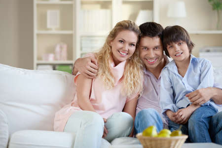 A happy family with a child at homeの写真素材