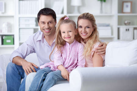 A happy family with a child at homeの写真素材