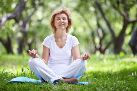 Mature woman in a park yogaの写真素材