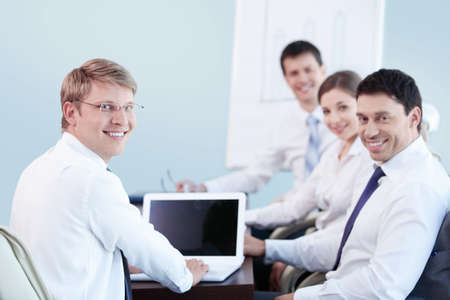 Young people with a laptop in the officeの写真素材