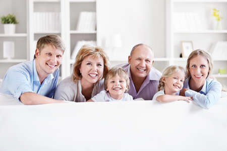 Happy big family with children at homeの写真素材