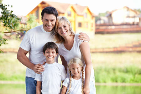 Happy family homes on the backgroundの写真素材