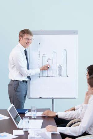 Young man shows a presentation at the officeの写真素材