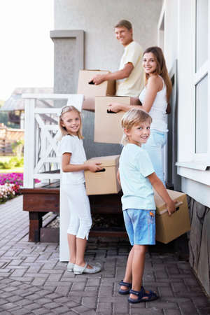 Family with boxes in the house