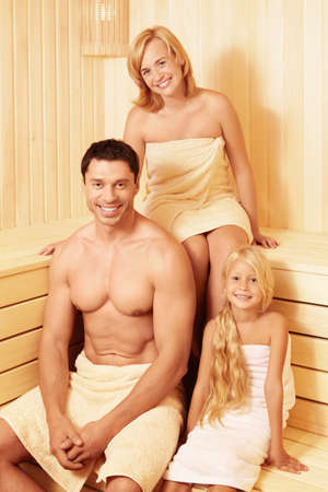 Happy family in the saunaの写真素材