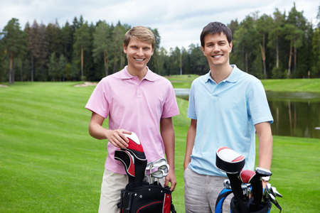 Two young men on the golf courseの写真素材