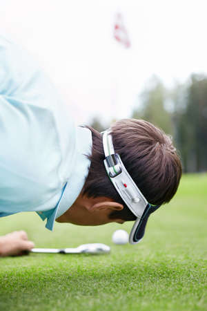 A young man playing golfの写真素材