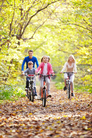 Family on bikes in the park
