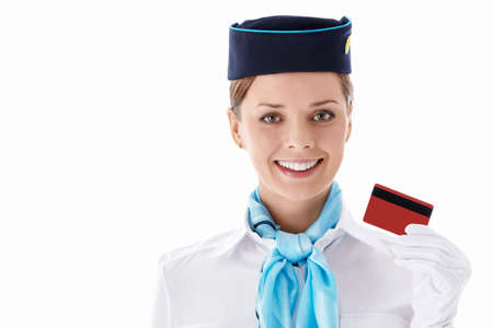 Stewardess with a credit card on a white backgroundの写真素材