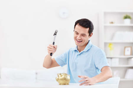 A man breaks the piggy bankの写真素材