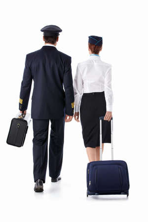 The pilot and flight attendant with a suitcase isolatedの写真素材