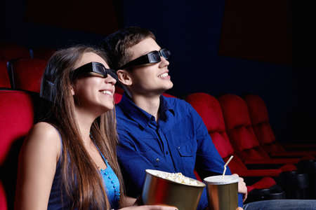 Happy couple in a movie theaterの写真素材