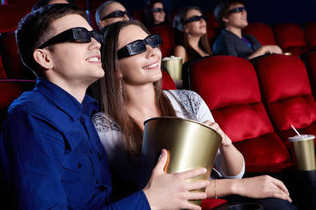 Young people in the 3D glasses at the cinemaの写真素材