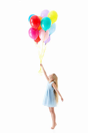 Little girl with balloons on a white backgroundの写真素材