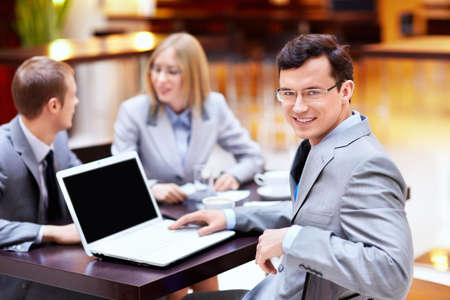 Young man in a suit with a laptop