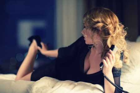 Beautiful young girl with phoneの写真素材