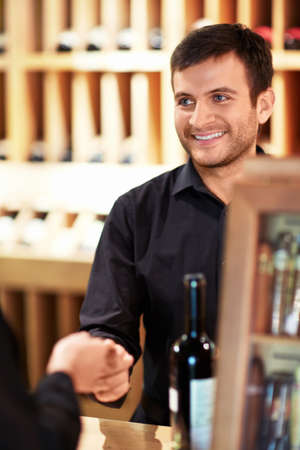 Buying wine at the storeの写真素材